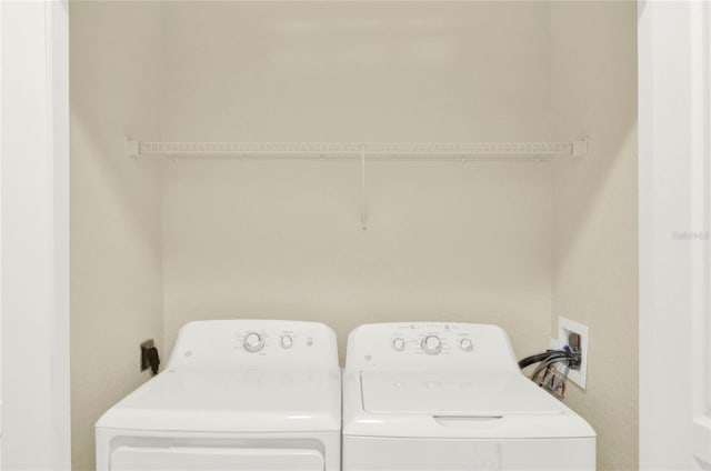 clothes washing area with washing machine and clothes dryer