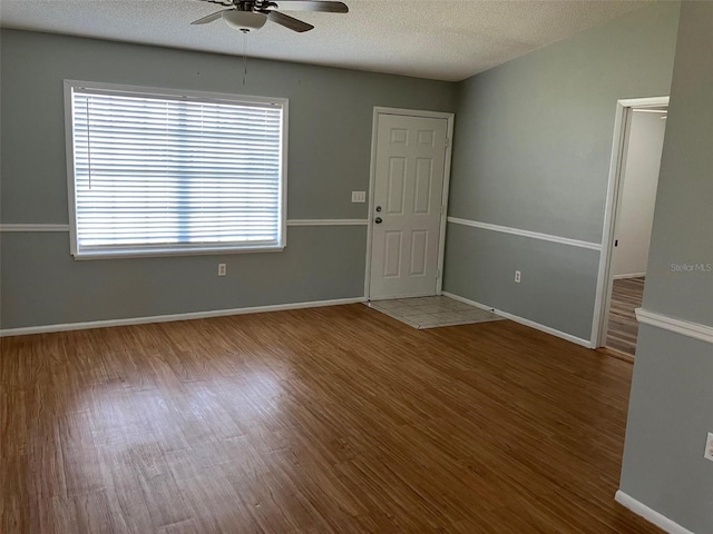 spare room featuring ceiling fan, hardwood / wood-style floors, and a textured ceiling