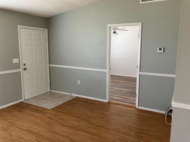 spare room with hardwood / wood-style flooring and a textured ceiling