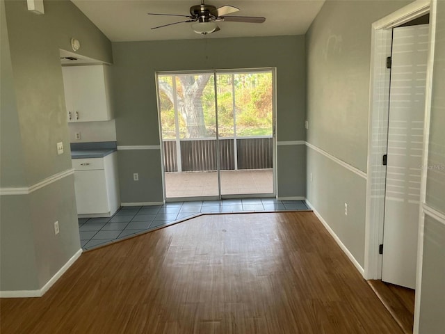 unfurnished dining area featuring hardwood / wood-style flooring, lofted ceiling, and ceiling fan