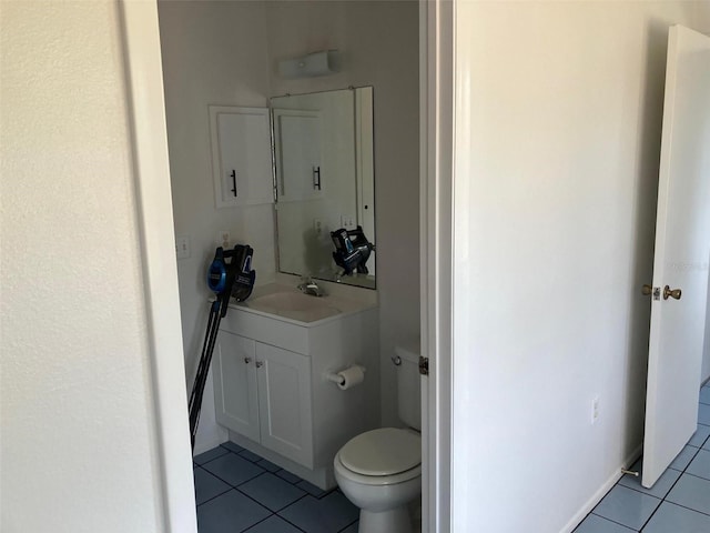 bathroom with tile patterned flooring, vanity, and toilet