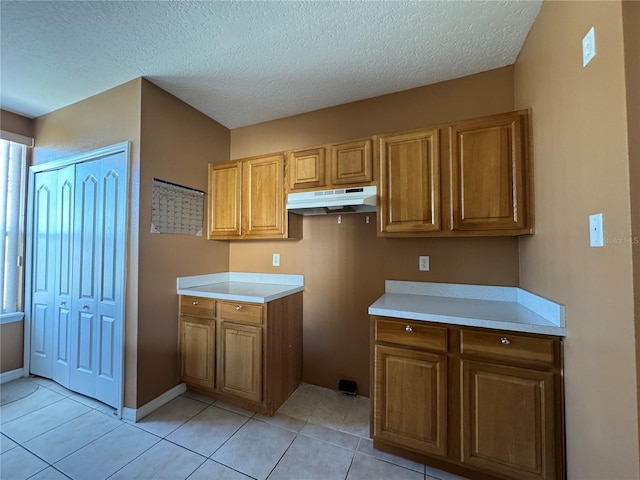 kitchen featuring light tile patterned floors and a textured ceiling