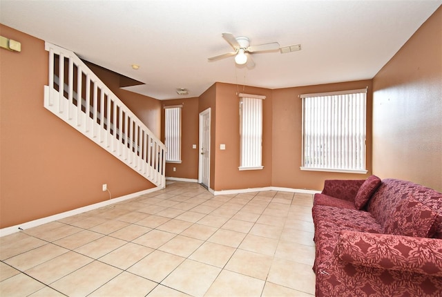 unfurnished living room with ceiling fan and light tile patterned flooring