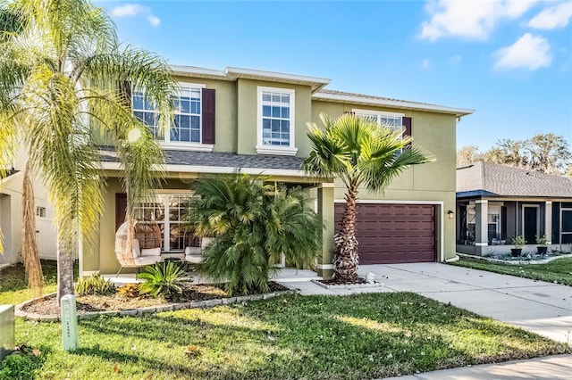 townhome / multi-family property featuring a garage and a front lawn