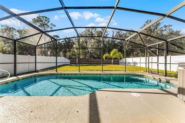 view of swimming pool with a yard, a lanai, and a patio area