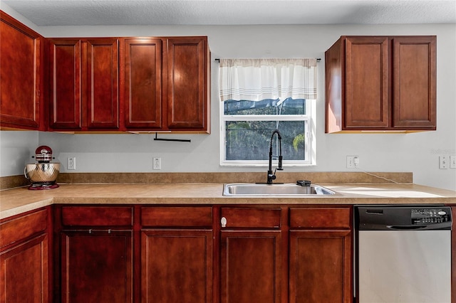 kitchen featuring sink, stainless steel dishwasher, and a textured ceiling