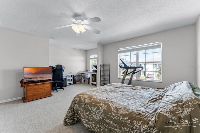 carpeted bedroom with a textured ceiling and ceiling fan