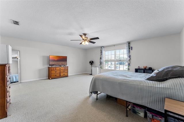 carpeted bedroom with a textured ceiling and ceiling fan