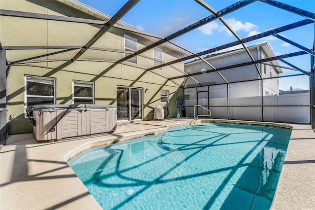 view of pool featuring a hot tub, a patio, and a lanai