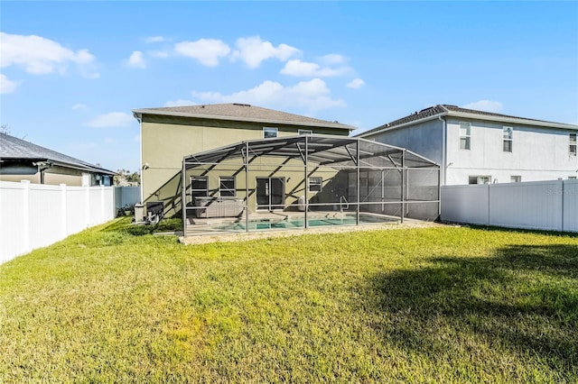 rear view of house with a fenced in pool, a yard, a patio area, and glass enclosure