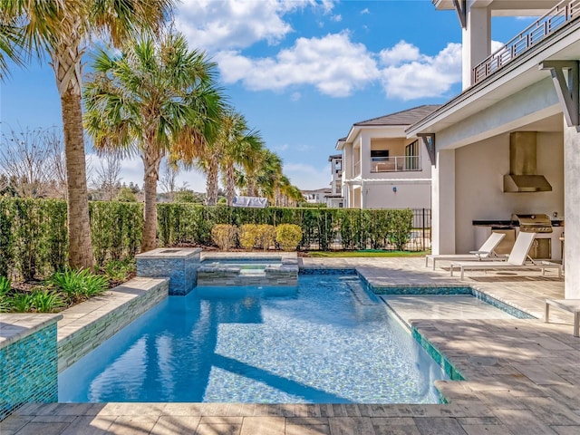 view of swimming pool with area for grilling, a patio, and an in ground hot tub