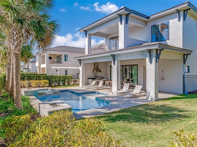 rear view of house featuring a swimming pool with hot tub, a lawn, a patio, area for grilling, and a balcony