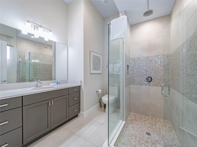 bathroom with vanity, a shower with shower door, tile patterned floors, and toilet