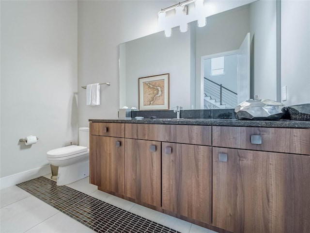 bathroom featuring vanity, tile patterned floors, and toilet