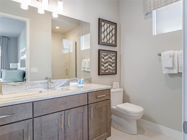 bathroom featuring vanity, a shower with door, tile patterned floors, and toilet