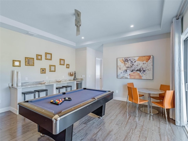 rec room featuring pool table, light hardwood / wood-style floors, and a raised ceiling