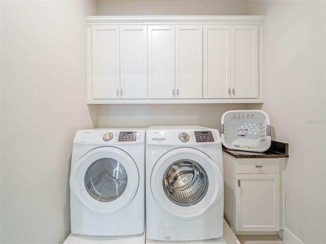 laundry area with cabinets and separate washer and dryer