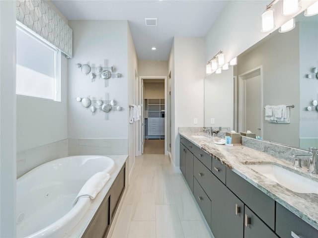 bathroom featuring vanity and a tub