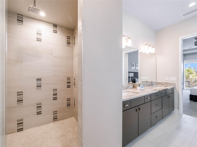 bathroom featuring vanity and tiled shower