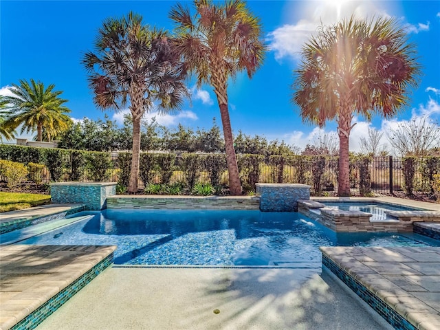 view of swimming pool featuring an in ground hot tub