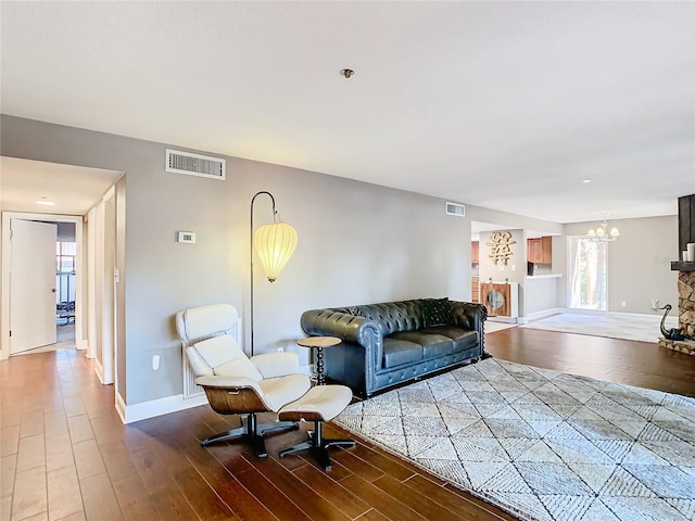 living room featuring an inviting chandelier and wood-type flooring