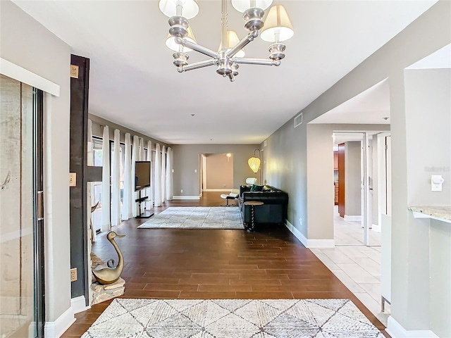 foyer with hardwood / wood-style flooring and a chandelier