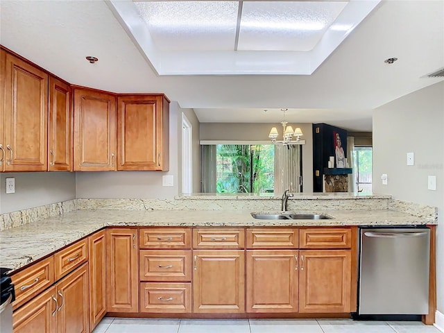 kitchen with light stone counters, plenty of natural light, dishwasher, and sink