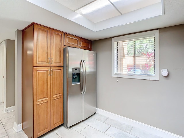 kitchen featuring stainless steel fridge and light tile patterned flooring