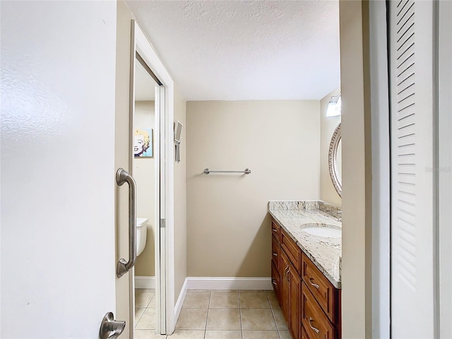 bathroom with vanity, tile patterned floors, and a textured ceiling