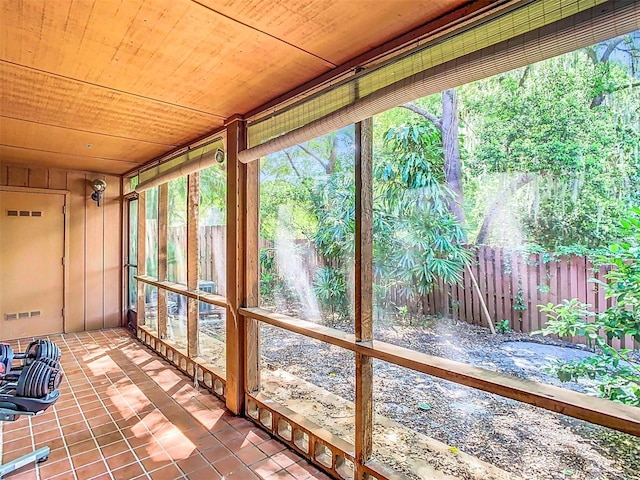 unfurnished sunroom with wooden ceiling