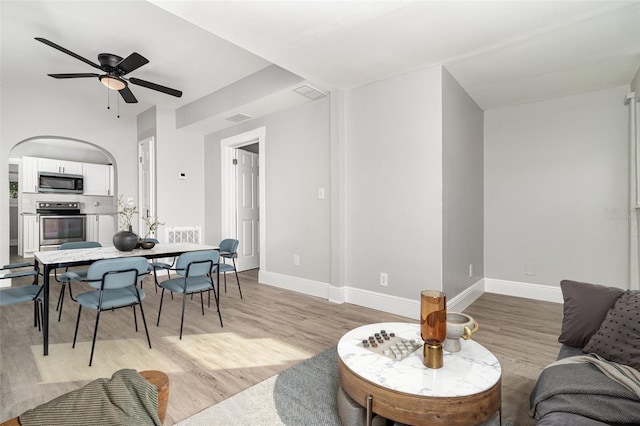 living room featuring ceiling fan and light hardwood / wood-style floors