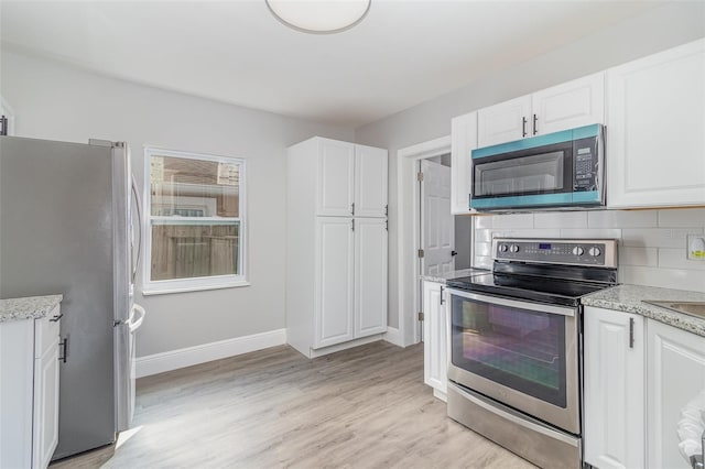 kitchen featuring stainless steel appliances and white cabinets