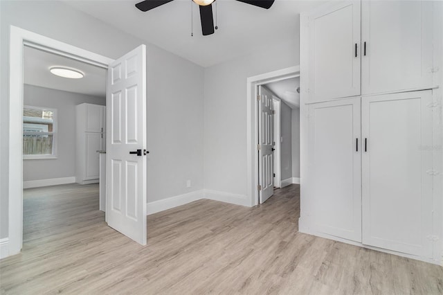 unfurnished bedroom with ceiling fan and light wood-type flooring