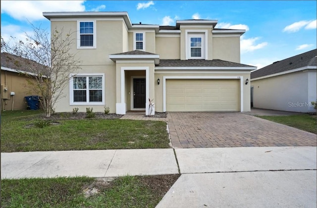 view of front of home with a garage and a front yard