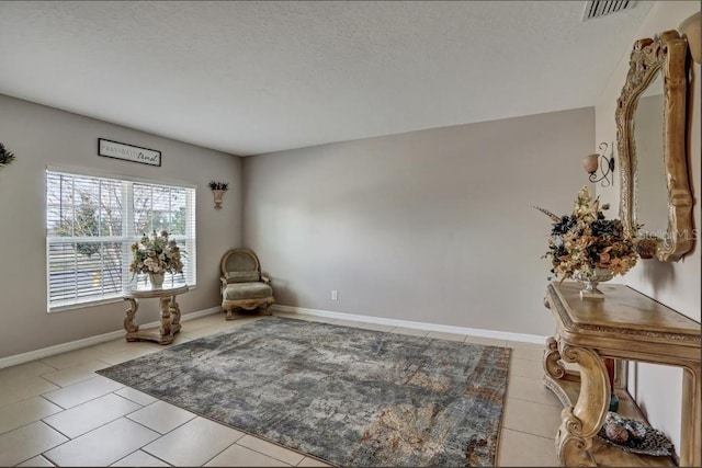 sitting room featuring light tile patterned floors and a textured ceiling