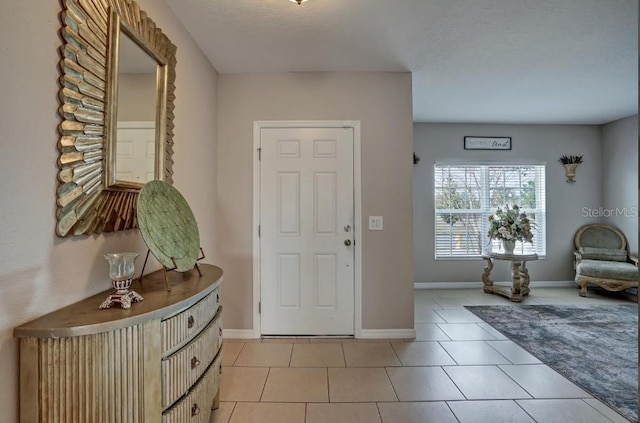 tiled foyer featuring a textured ceiling