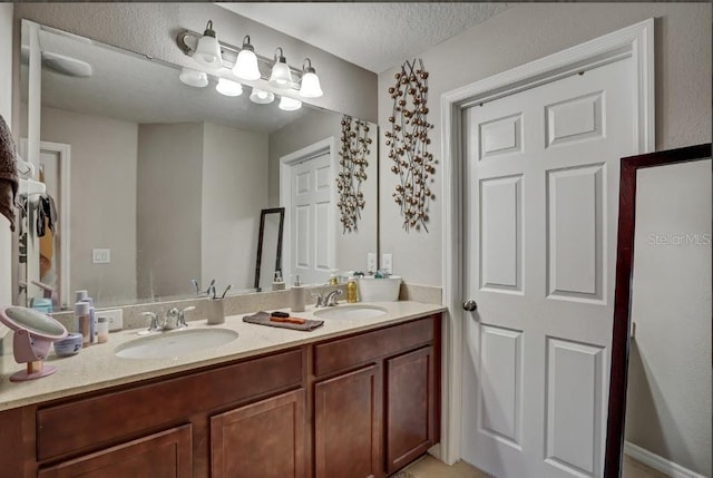 bathroom featuring vanity and a textured ceiling