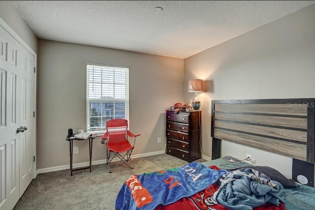 carpeted bedroom with a textured ceiling