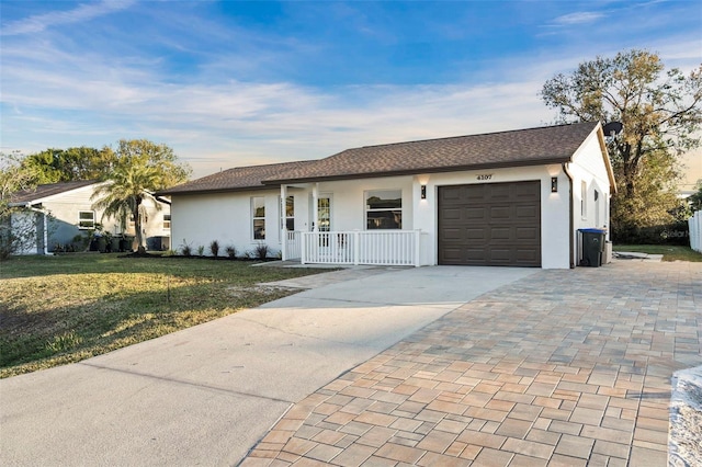 ranch-style house with a garage, a front yard, and a porch