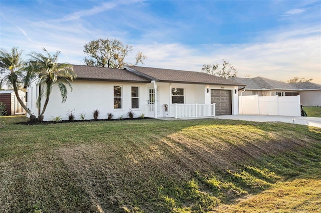 ranch-style home featuring a garage and a front lawn