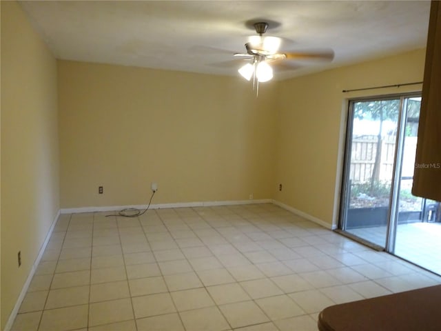 unfurnished room with baseboards, light tile patterned flooring, and a ceiling fan