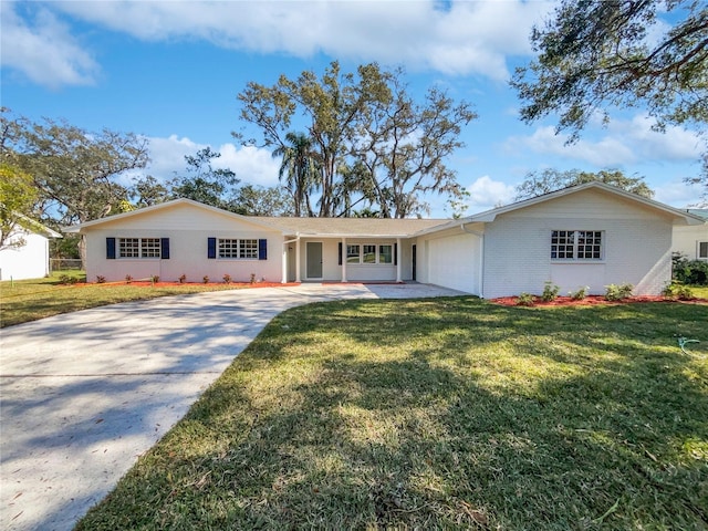 single story home with a garage and a front lawn