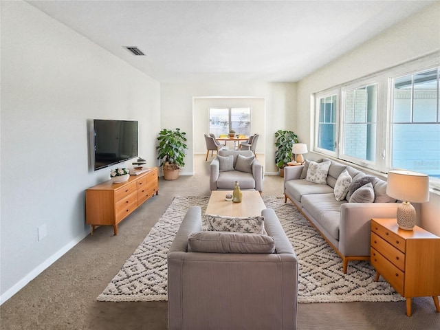 living room featuring a healthy amount of sunlight and carpet flooring