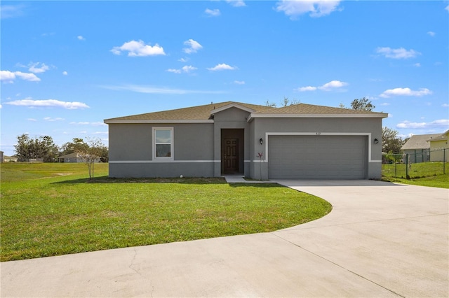 view of front of property featuring a garage and a front lawn