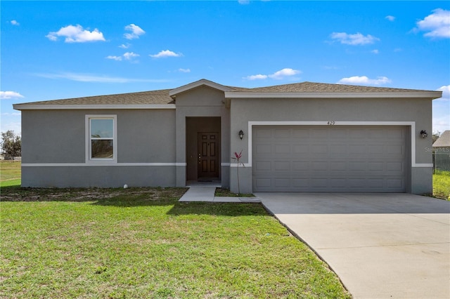 view of front of home featuring a garage and a front yard