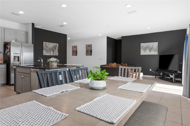 dining space with light tile patterned flooring and sink