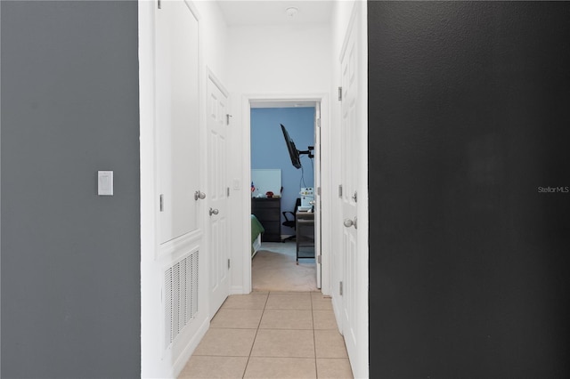 hall featuring light tile patterned floors