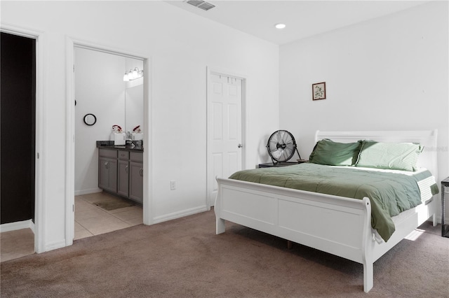 bedroom featuring carpet and ensuite bath