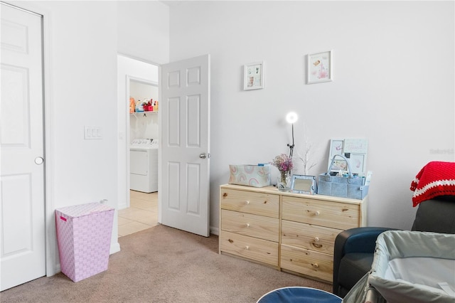 living area featuring light carpet and washer / dryer