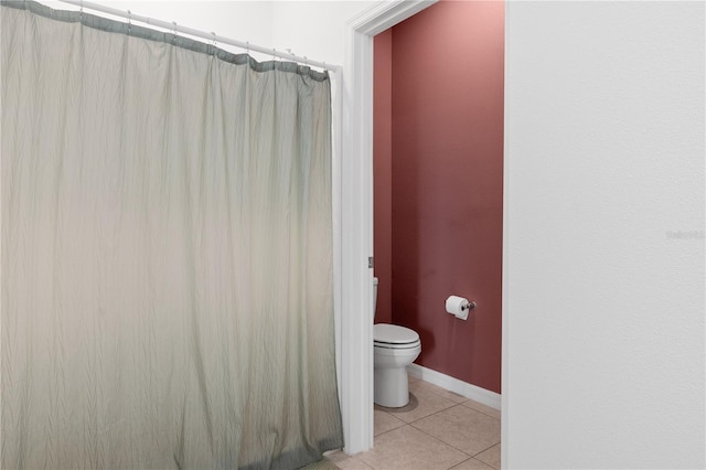 bathroom with tile patterned flooring and toilet